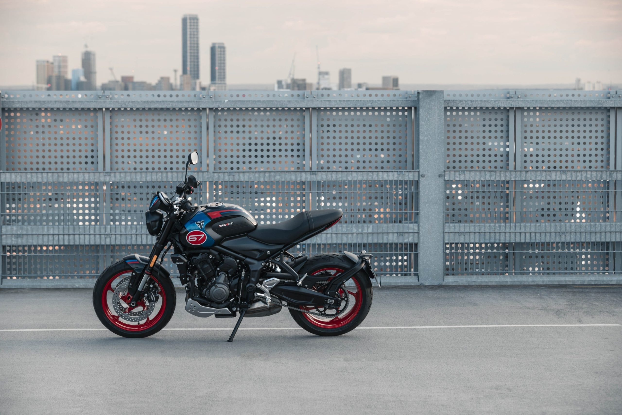 Triumph Chile recibe a la Trident 660 Triple Tribute, una naked de media cilindrada con una estética de competición retro, que homenajea los triunfos de la marca en el motociclismo deportivo. La misma cuenta con numerosas novedades en diseño, rendimiento y tecnología. La Triple Tribute tiene en su corazón un motor tricilíndrico de 660 cc, el cual ofrece una potencia máxima de 81 CV a 10.250 rpm y un torque de 64 Nm a 6.250 rpm. El acelerador electrónico y la curva de par lineal logran que la entrega de potencia sea intuitiva tanto en el uso citadino como al tomar curvas en la carretera. El silenciador lateral, compacto y minimalista, con un acabado de acero inoxidable, emite un inconfundible y profundo sonido. La motocicleta cuenta con seis velocidades que permiten una conducción sencilla, que mejora con la incorporación de serie del asistente Triumph Shift Assist, la tecnología propia del fabricante europeo que permite subir y bajar de marchas de forma suave y sin embrague, haciendo más fácil la conducción urbana y mucho más emocionantes los viajes por autopista. Por otro lado, el chasis tubular de acero se combina con las suspensiones de altas especificaciones. En el apartado de suspensiones equipa una horquilla invertida Showa SFF-BP de 41 mm como el amortiguador ajustable en precarga. En los neumáticos incorpora unos Michelin Road 5 que ofrecen un destacado agarre tanto en una superficie mojada como en seco, mientras que el doble disco de freno delantero de 310 mm con cáliper Nissin de dos pistones brinda una potencia de frenada suave y progresiva. Entre sus novedades se encuentra el ABS optimizado para curvas, el cual toma la información procedente de la unidad de medición inercial (IMU) y ajusta los parámetros de cada frenada según la inclinación, ofreciendo el máximo control y confianza en las curvas. El nuevo control de tracción optimizado para curvas ajusta la entrega de potencia en función del ángulo de inclinación y del agarre del asfalto en cada momento para mantener el control según el modo de conducción seleccionado. Los modos de conducción Road, Rain y el nuevo Sport ajustan la respuesta del acelerador y el control de tracción para adaptarse a las condiciones del piso o al estilo del conductor. La nueva Trident 660 Triple Tribute tiene una garantía de cuatro años, con intervalos de mantenimiento cada 16.000 km o 12 meses. En el mercado chileno tendrá un precio de lanzamiento desde $ 9.090.000 (financiamiento vía Forum y bono de marca de $ 200.000). Además, se puede personalizar con una gama de 32 accesorios, que incluye protectores para el depósito, el chasis y las tapas del motor, toma USB, kit de equipaje resistente al agua, puños calefactables, alarma, rastreador y múltiples candados, entre otros.