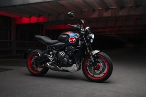 Triumph Chile recibe a la Trident 660 Triple Tribute, una naked de media cilindrada con una estética de competición retro, que homenajea los triunfos de la marca en el motociclismo deportivo. La misma cuenta con numerosas novedades en diseño, rendimiento y tecnología. La Triple Tribute tiene en su corazón un motor tricilíndrico de 660 cc, el cual ofrece una potencia máxima de 81 CV a 10.250 rpm y un torque de 64 Nm a 6.250 rpm. El acelerador electrónico y la curva de par lineal logran que la entrega de potencia sea intuitiva tanto en el uso citadino como al tomar curvas en la carretera. El silenciador lateral, compacto y minimalista, con un acabado de acero inoxidable, emite un inconfundible y profundo sonido. La motocicleta cuenta con seis velocidades que permiten una conducción sencilla, que mejora con la incorporación de serie del asistente Triumph Shift Assist, la tecnología propia del fabricante europeo que permite subir y bajar de marchas de forma suave y sin embrague, haciendo más fácil la conducción urbana y mucho más emocionantes los viajes por autopista. Por otro lado, el chasis tubular de acero se combina con las suspensiones de altas especificaciones. En el apartado de suspensiones equipa una horquilla invertida Showa SFF-BP de 41 mm como el amortiguador ajustable en precarga. En los neumáticos incorpora unos Michelin Road 5 que ofrecen un destacado agarre tanto en una superficie mojada como en seco, mientras que el doble disco de freno delantero de 310 mm con cáliper Nissin de dos pistones brinda una potencia de frenada suave y progresiva. Entre sus novedades se encuentra el ABS optimizado para curvas, el cual toma la información procedente de la unidad de medición inercial (IMU) y ajusta los parámetros de cada frenada según la inclinación, ofreciendo el máximo control y confianza en las curvas. El nuevo control de tracción optimizado para curvas ajusta la entrega de potencia en función del ángulo de inclinación y del agarre del asfalto en cada momento para mantener el control según el modo de conducción seleccionado. Los modos de conducción Road, Rain y el nuevo Sport ajustan la respuesta del acelerador y el control de tracción para adaptarse a las condiciones del piso o al estilo del conductor. La nueva Trident 660 Triple Tribute tiene una garantía de cuatro años, con intervalos de mantenimiento cada 16.000 km o 12 meses. En el mercado chileno tendrá un precio de lanzamiento desde $ 9.090.000 (financiamiento vía Forum y bono de marca de $ 200.000). Además, se puede personalizar con una gama de 32 accesorios, que incluye protectores para el depósito, el chasis y las tapas del motor, toma USB, kit de equipaje resistente al agua, puños calefactables, alarma, rastreador y múltiples candados, entre otros.